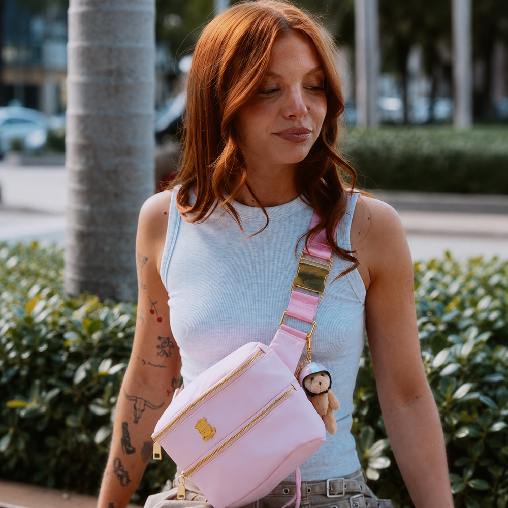 Strawberry Milk Pink belt bag worn crossbody with the bear charm